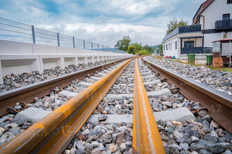 A railway track runs through a landscape with buildings in the background, under a cloudy sky, track construction, rail delivery for Hermann Hessebahn, Calw, Black Forest, Germany, Europe