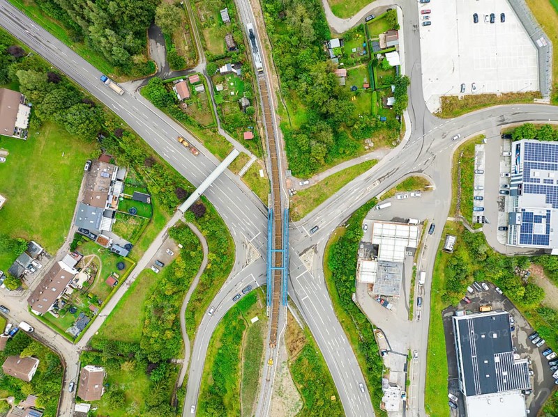 Aerial view of a road crossing with railway bridge in urban surroundings, track construction, rail delivery for Hermann Hessebahn, Calw, Black Forest, Germany, Europe