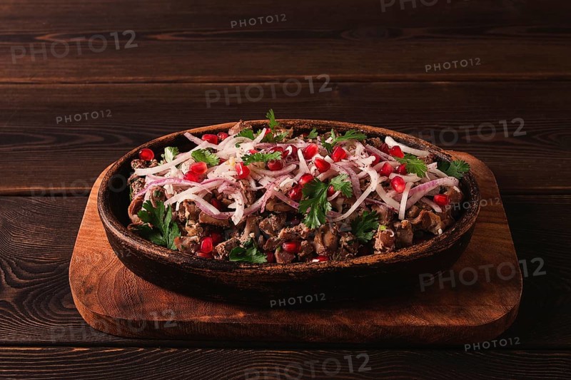 Kuchmachi, a traditional Georgian dish, in a clay Ketsi plate, close-up