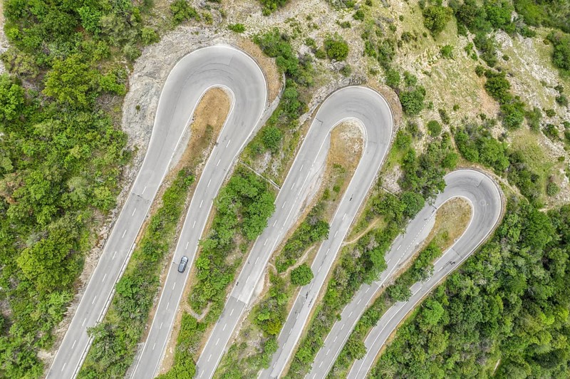 Aerial view, drone shot, Mountain pass road with multiple hairpins, water pipeline, Switzerland, Europe