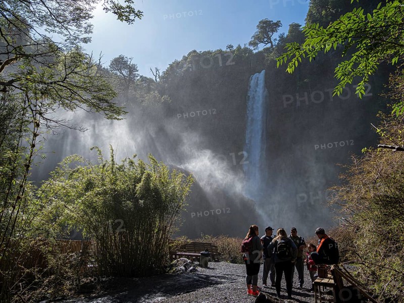 Tourists in front of waterfall Salto El Leon, valley of waterfalls east of Pucon, La Auracania, Chile, South America