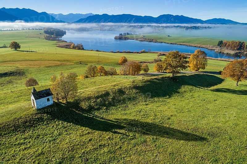 Aerial view of a small chapel in front of a lake, mountain landscape, autumn, sunny, Riegsee, Alpine foothills, Upper Bavaria, Bavaria, Germany, Europe