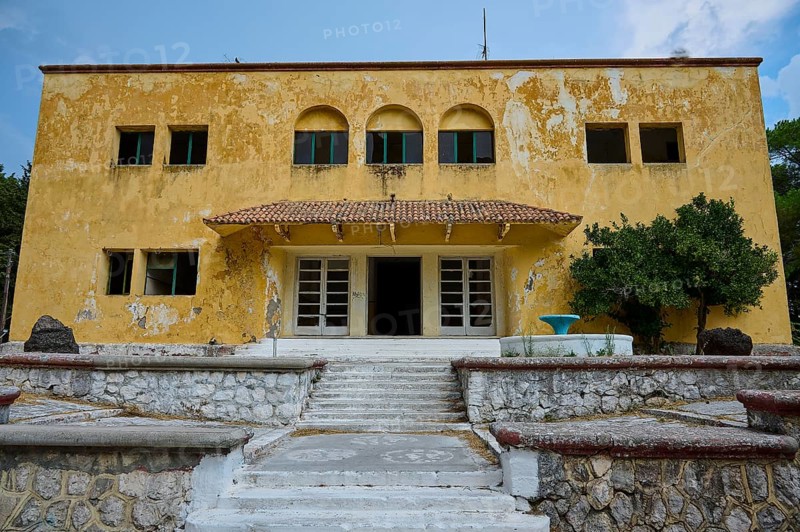 An old yellow dilapidated building with a damaged façade and a staircase in the entrance, Italian Governor's Palace, Ruins, Italian colonial settlement, Eleousa, Rhodes, Dodecanese, Greek Islands, Greece, Europe