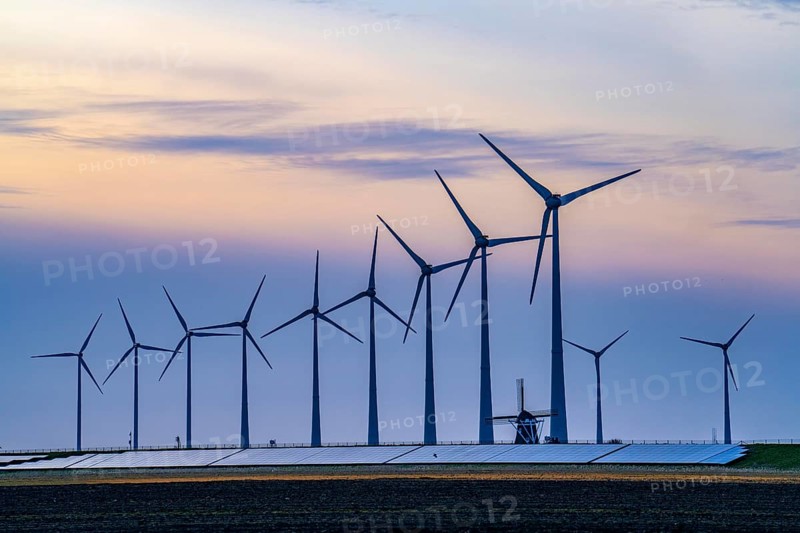 Windmill Poldermolen De Goliath stands between the high-tech wind turbines in Eemshaven, historic windmill from around 1882, rebuilt and reconstructed several times, Westereems wind farm, solar farm on sea dike, Slaperdijk, a good 5 kilometres long, Netherlands