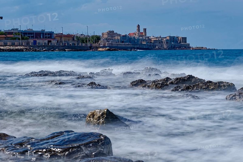 Rocky beach and gentle waves in the Mediterranean near Giovinazzo in the province of Bari. Giovinazzo, Apulia, Southern Italy, Southern Europe