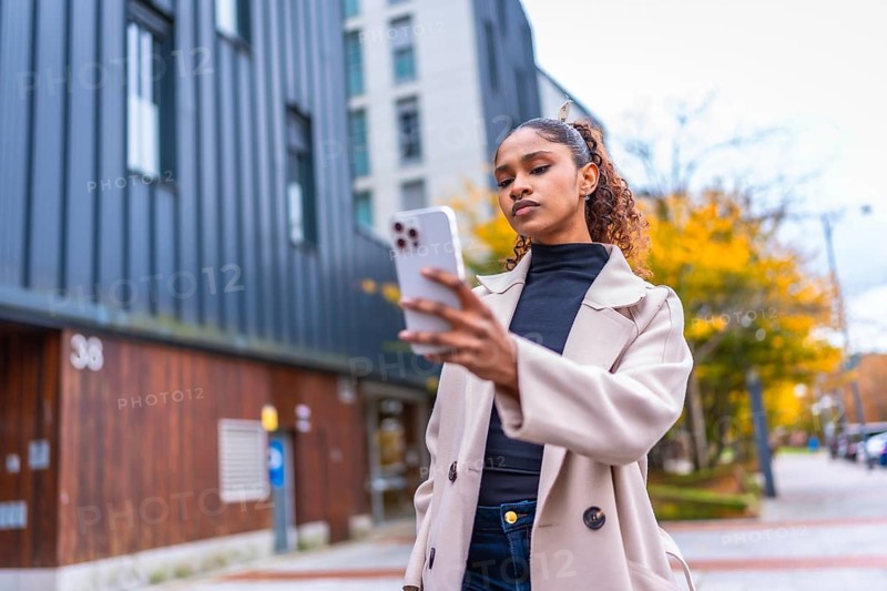 Beauty african woman using smartphone to find a direction in the city