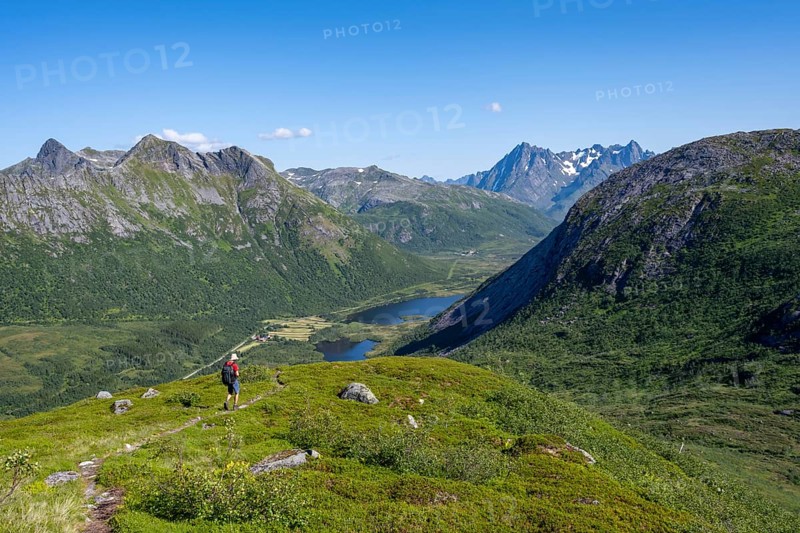 View of mountain landscape, mountaineer on hiking trail to the summit of Rundfjellet, Svolvaer, Nordland, NorwayView of mountain landscape, mountaineer on hiking trail to the summit of Rundfjellet, Svolvaer, Nordland, Norway, Europe