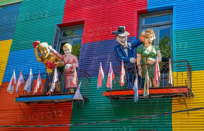 La Boca, Buenos Aires, Argentina, colourfully painted houses in the harbour district around the El Caminito alley. Figures of Argentinian personalities greet you on a balcony above a shop. La Boca emerged at the end of the 19th century as a neighbourhood of Italian immigrants, most of whom worked as industrial workers. Today, the working-class neighbourhood is popular with tourists, partly because of its original houses, often built from the sheet metal of scrapped ships and brightly painted with ship paint, South America