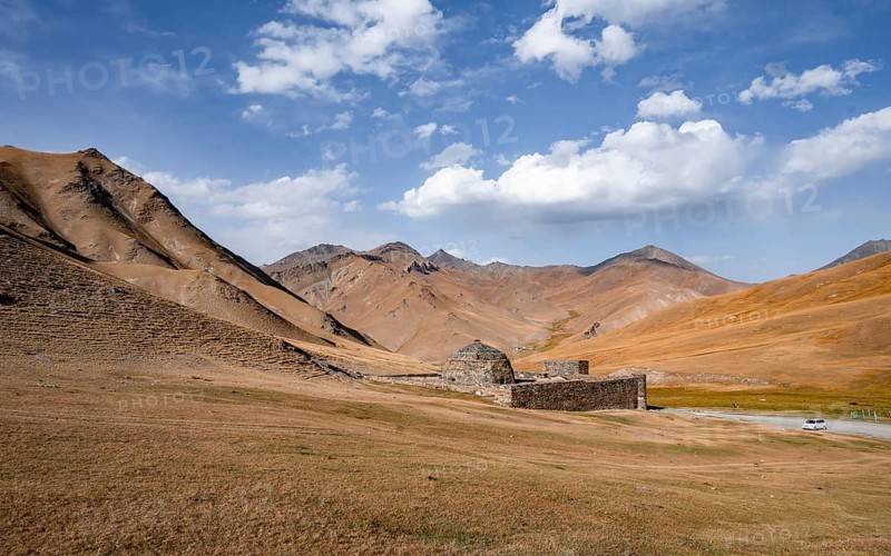 Historic caravanserai Tash Rabat from the 15th century, with yellow hills, Atbashy district in the Naryn region, Kyrgyzstan, Asia