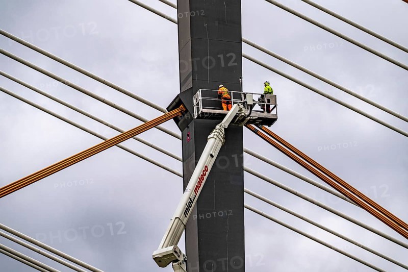 The new Rhine bridge Neuenkamp, the A40, white pillar ropes, and the old motorway bridge, which is being dismantled, preparation for demolition, workers on cherry pickers measure, mark the old bridge pillar, Duisburg, North Rhine-Westphalia, Germany, Europe
