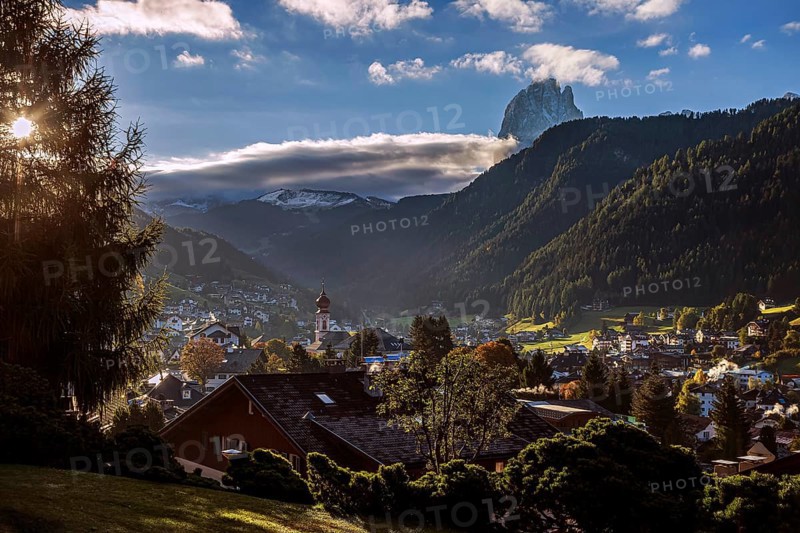 The mountain village of Ortisei in Val Gardena at sunrise, surrounded by wooded mountains and snow-capped peaks, picturesque atmosphere, Val Gardena, South Tyrol, Italy, Europe