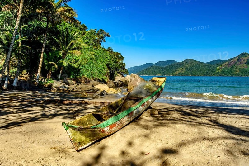 Fishing canoe over beach sandof Castelhanos beach in Ilhabela, Castelhanos beach, Ilhabela, Sao Paulo, Brazil, South America