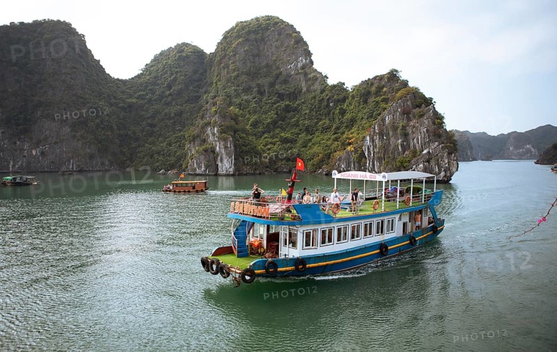 Excursion boat and the karst rocks in Lan Ha Bay, Halong Bay, Vietnam, Asia