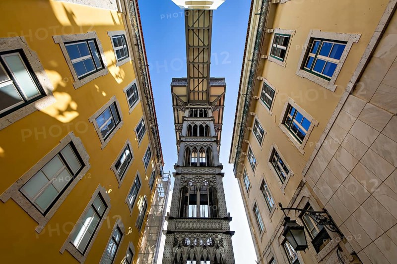 View from below of the Santa Justa Lift, an historical elevator in Lisbon, contrasting with the blue sky, Elvador De Santa Justa, Lisbon