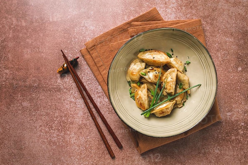Japanese fried gyoza dumplings, with pork, sesame seeds, green onions