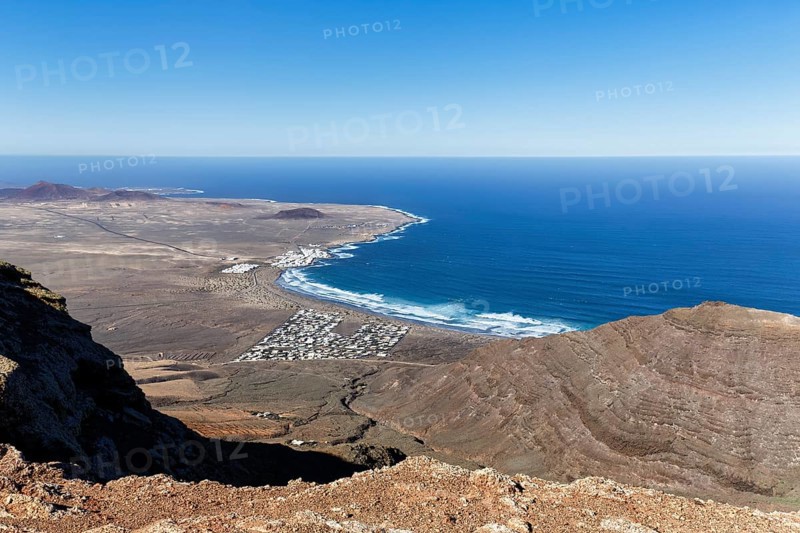 View of the coastline and the holiday homes, Mirador Ermita de las Nieves, Caleta de Famara, Lanzarote, Canary Islands, Spain, Europe