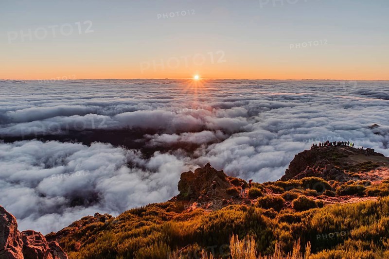 View over a sea of clouds at sunrise from a mountain peak with a calm and charming atmosphere, Pico Ruivo, Madeira, Portugal, Europe