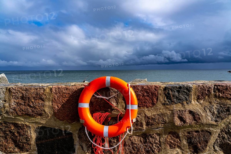 The city harbour of Sassnitz, island of Rügen, pier, harbour dam, dark rain clouds, lifebuoy, Mecklenburg-Vorpommern, Germany, Europe