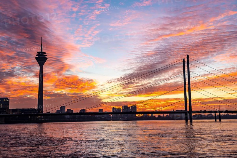 Winter sunset on the Rhine near Düsseldorf, Rhine Tower, cargo ship, Rhine knee bridge, North Rhine-Westphalia, Germany, Europe