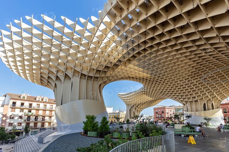 Imposing wooden structure Metropol Parasol under a blue sky, with spacious open areas, Seville