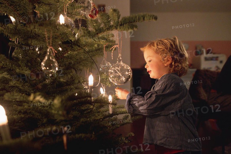 Toddler at the Christmas tree at the family Christmas party, Bonn, 24.12.2023. Toddler at the Christmas tree
