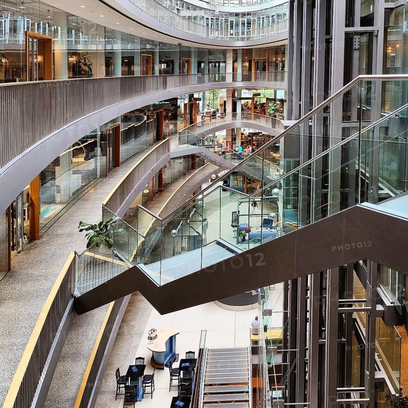 Stilwerk Düsseldorf, free-floating staircase in the elliptical atrium with surrounding galleries on five sales floors, Germany, Europe