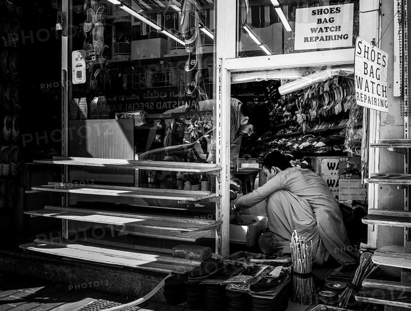 Black and white photography, shoe shops and craftsmen in Al Fahidi neighbourhood, Dubai, United Arab Emirates, Asia