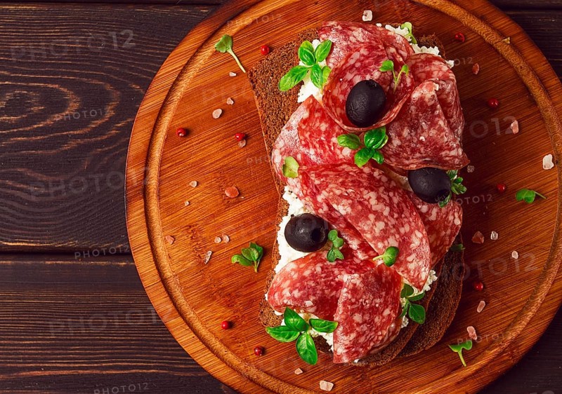 Sandwich, grain bread, with cream cheese and salami, black olives, micro-greens, top view, close-up, no people, Breakfast