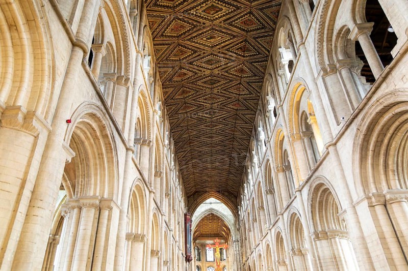 Interior of cathedral church, Peterborough, Cambridgeshire, England, UK looking up at ceiling and sculpture of Jesus Christ on Cross