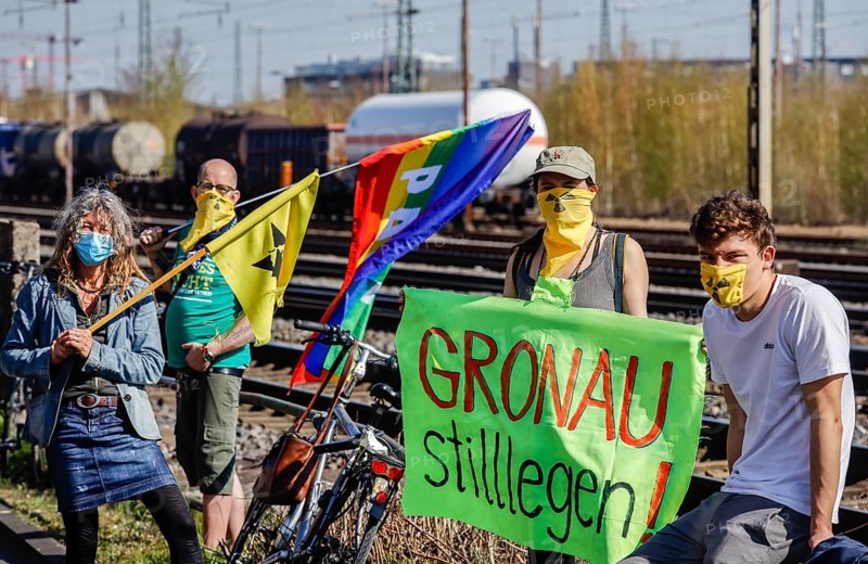 Münster, North Rhine-Westphalia, Germany - Anti-nuclear demonstration in times of the corona crisis in compliance with the protection rules with distance and mouth protection, nuclear opponents demonstrate at Münster freight station against the Castor transport from Gronau, against the uranium waste transport from the uranium enrichment plant Gronau to the Russian nuclear factory Novouralsk