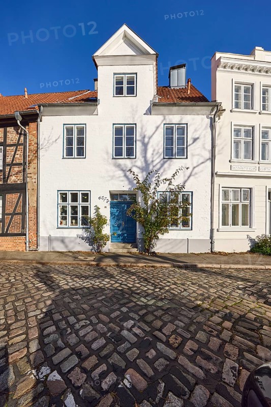 Historic house, dormer, façade with windows and door, street An der Obertrave made of cobblestones, Old Town, Hanseatic City of Lübeck, independent city, Schleswig-Holstein, Germany, Europe
