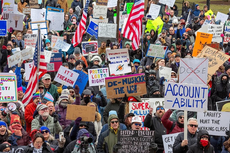 Lansing, Michigan USA - 5 February 2025 - People rally at the Michigan state capitol to oppose President Trump, Elon Musk, and Project 2025. Similar rallies were planned across the country, many of them at state capitols