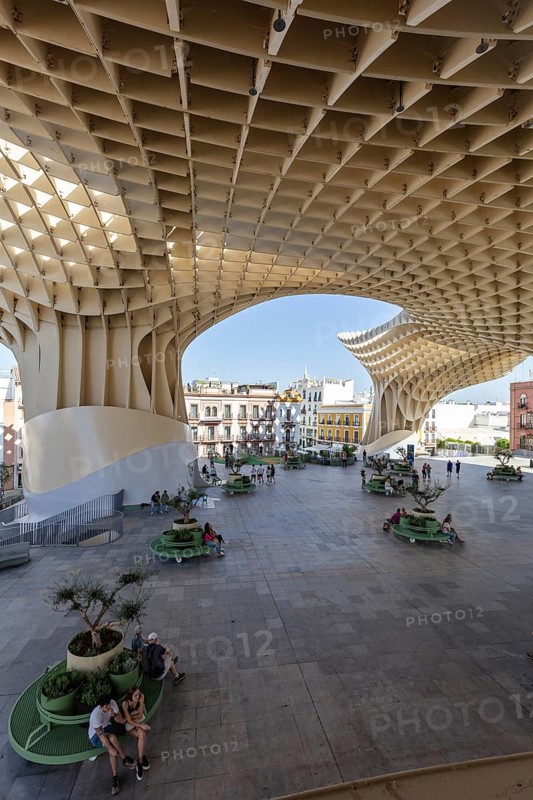 Modern architecture of the Metropol Parasol with people enjoying the shade in the square, Seville
