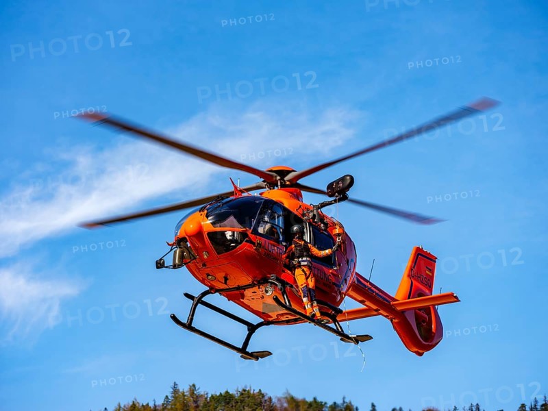 On-board mechanic of the rescue helicopter Christoph 14 winching with the cable winch, Bad Reichenhall, Berchtesgadener Land, Upper Bavaria, Bavaria, Germany, Europe