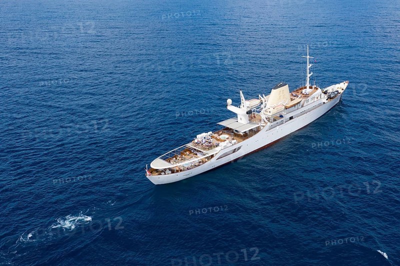 Aerial view 99 metre long motor yacht Christina O, former frigate built in 1942 by Canadian Vickers, converted for Aristotle Onassis, on board were Maria Callas, Winston Churchill, John F. and Jackie Kennedy, Tito, Grace Kelly, Prince Rainier III of Monaco, Frank Sinatra, Richard Burton, Elizabeth Taylor, Greta Garbo, John Wayne, Marilyn Monroe, John D. Rockefeller, Paul McCartney, Prince Andrew, Sarah Ferguson, Madonna, Johnny Depp. Here the yacht is cruising off Menton on the French Riviera, Mediterranean Sea