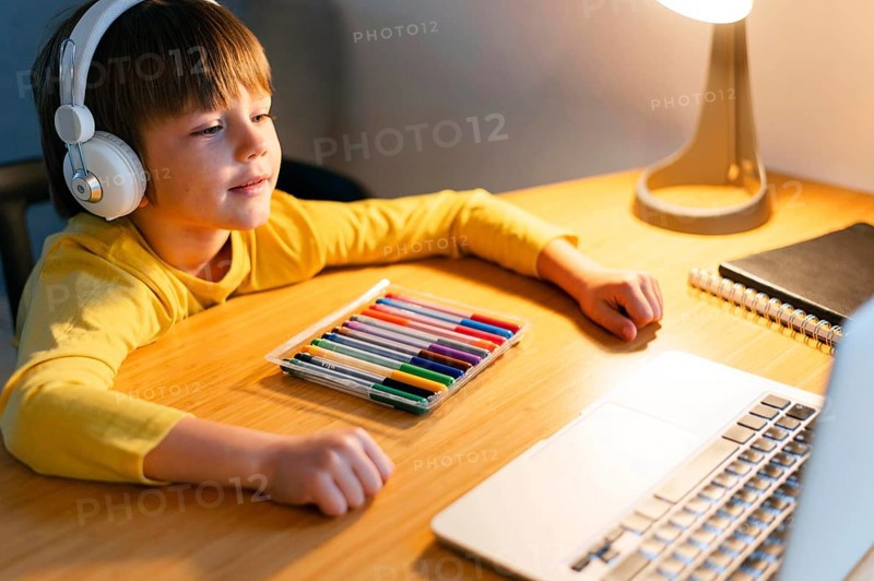High view child taking virtual courses