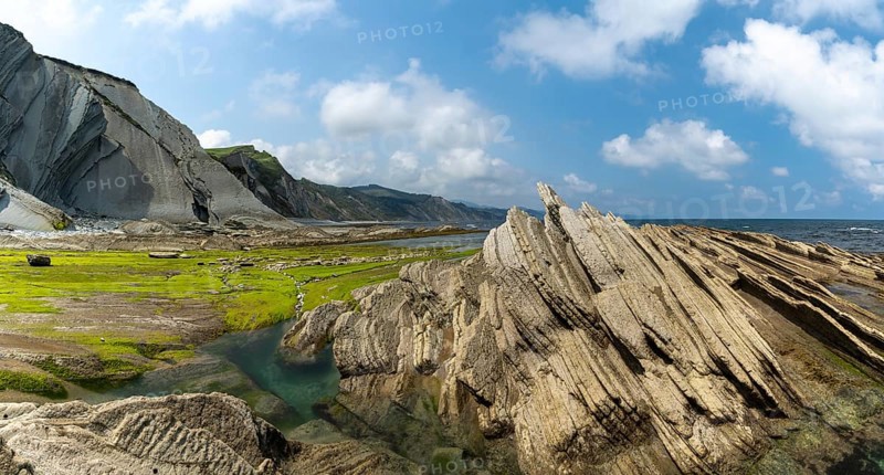 A panorama view of the Flysch rock formations and cliffs with tidal pools on the Basque Country coast near Zumaia