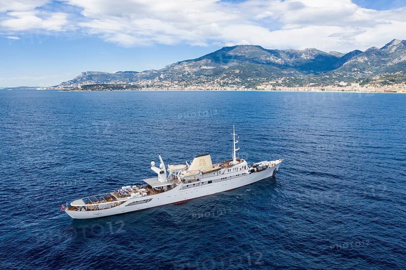 Aerial view 99 metre long motor yacht Christina O, former frigate built in 1942 by Canadian Vickers, converted for Aristotle Onassis, on board were Maria Callas, Winston Churchill, John F. and Jackie Kennedy, Tito, Grace Kelly, Prince Rainier III of Monaco, Frank Sinatra, Richard Burton, Elizabeth Taylor, Greta Garbo, John Wayne, Marilyn Monroe, John D. Rockefeller, Paul McCartney, Prince Andrew, Sarah Ferguson, Madonna, Johnny Depp. Here the yacht is cruising off Menton on the French Riviera, Mediterranean Sea