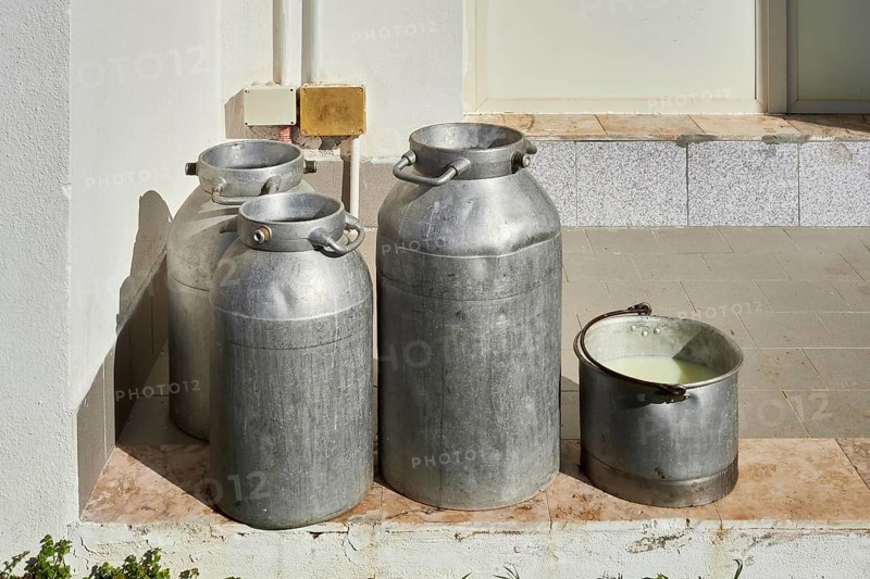 Some milk cans waiting to be taken away