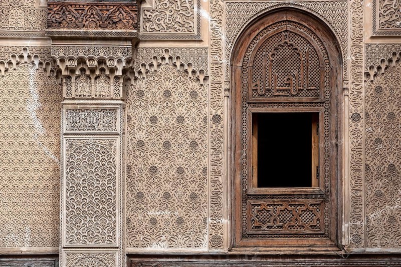 Fes, Morocco, April 04, 2023, Rich decorated facade in the courtyard of the Medersa Attarine in Fes, Morocco, Africa