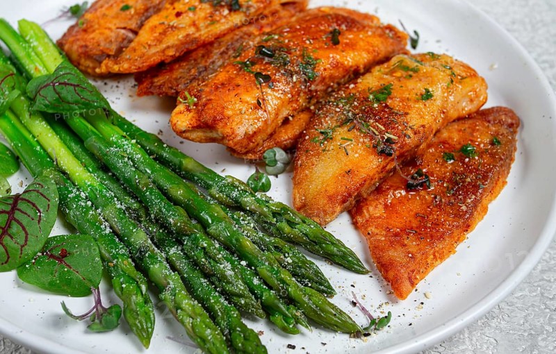 Fried fish fillet, tilapia with asparagus, homemade, no people