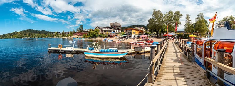 Panoramic view of the pier with tourists in summer on Lake Titisee in the Black Forest of Germany