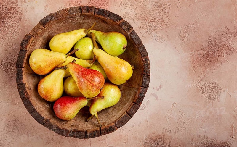 Pears, Duchess variety, small pears, early harvest, in a wooden plate, top view, no people
