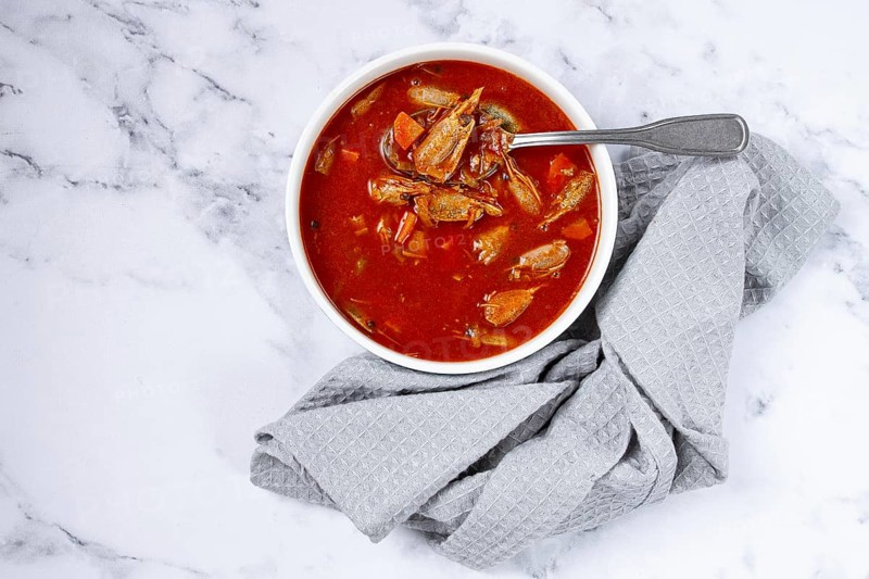 French shrimp bisque soup, on a marble table, close-up, no people