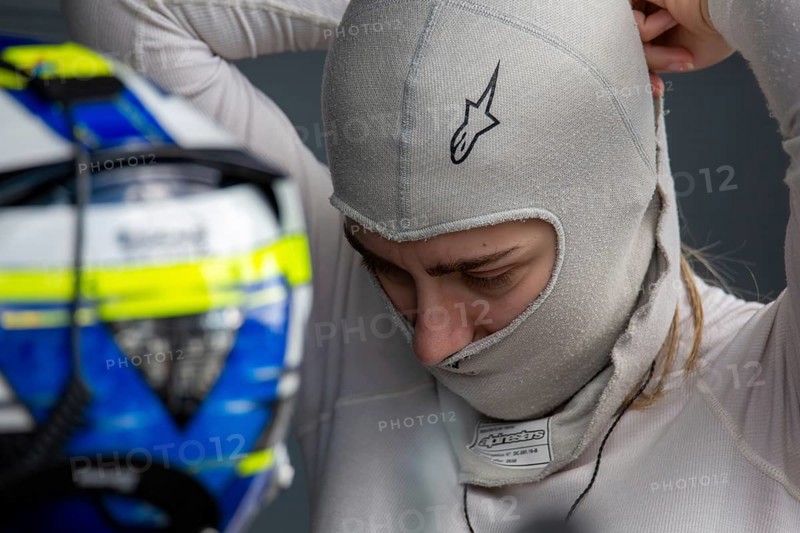 10 May 2024, Hockenheimring Germany : Spanish racing driver Alba Vazquez puts on her balavlava and gets ready to get into the cockpit (GT Open)