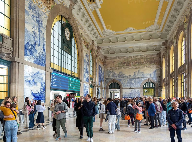 Tour groups viewing historic azulejos tiles, Sao Bento railway station building, city of Porto, Portugal, Europe