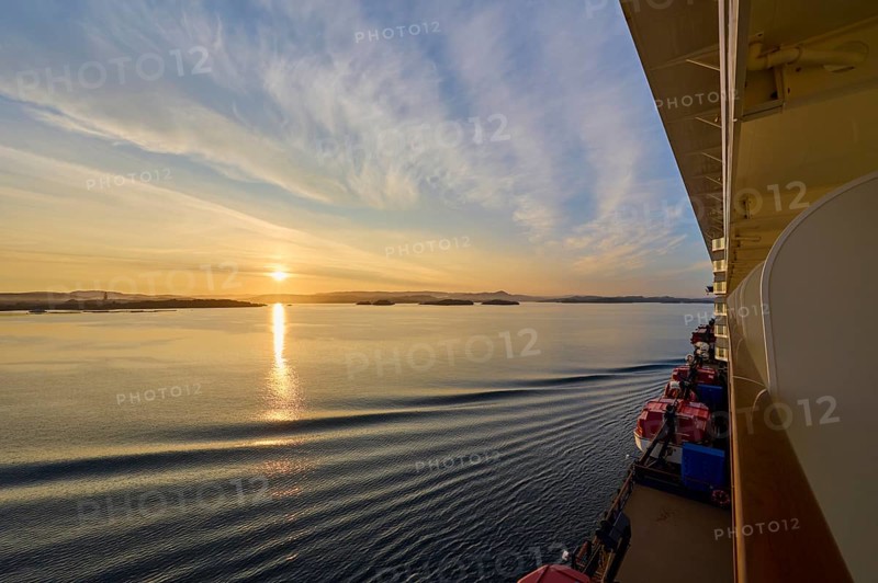 View from a cruise ship, Mein Schiff 6, of the calm sea at sunrise with soft clouds in the sky, Bergen, Vestland, Norway, Europe