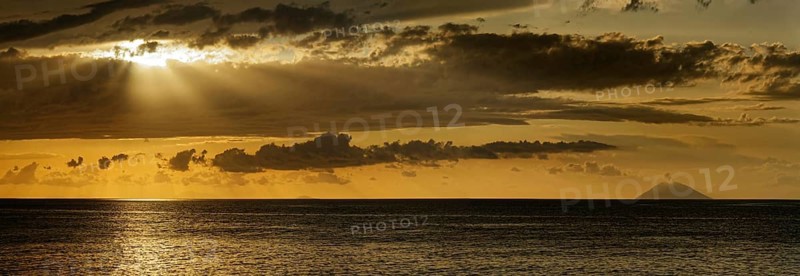 Sunset on the beach of Tropea with the Aeolian (Liparic) Islands and the volcanic island of Stromboli on the horizon, Tropea, Vibo Valentia, Calabria, Southern Italy, Italy, Europe