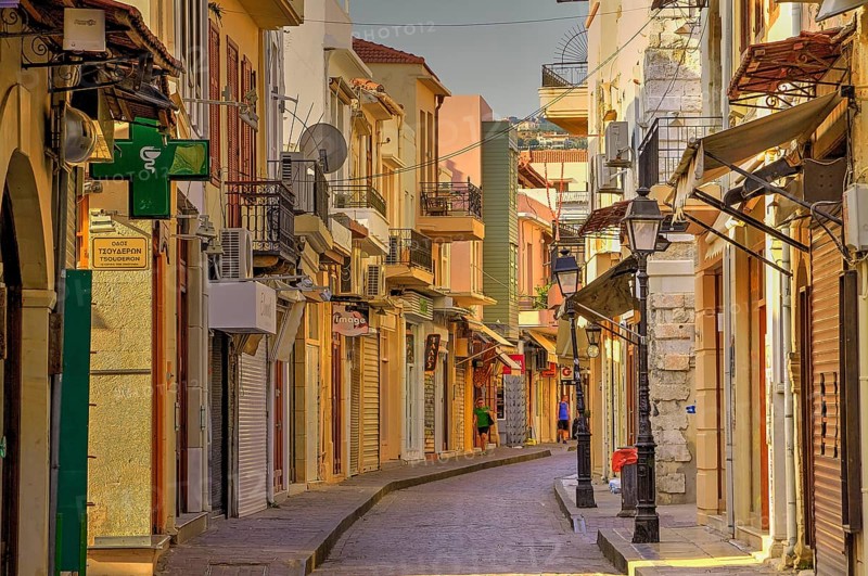 Venetian old town, old town alley almost deserted, colourful houses, cobbled alleyway, morning light, Rethimnon, central Crete, island of Crete, Greece, Europe