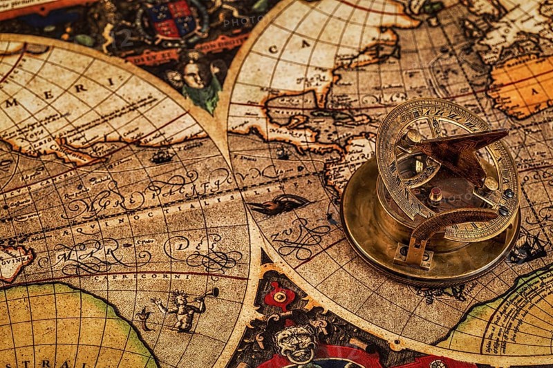 Travel geography navigation concept background, old vintage retro compass with sundial on ancient world map